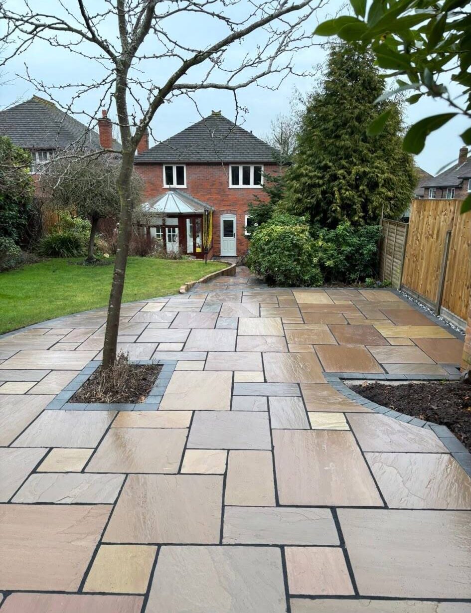 Paved patio area surrounded by landscaped garden