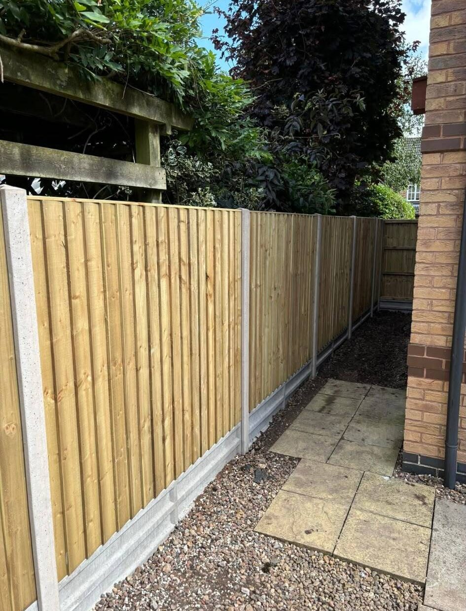 New fence panels installed along a residential property boundary