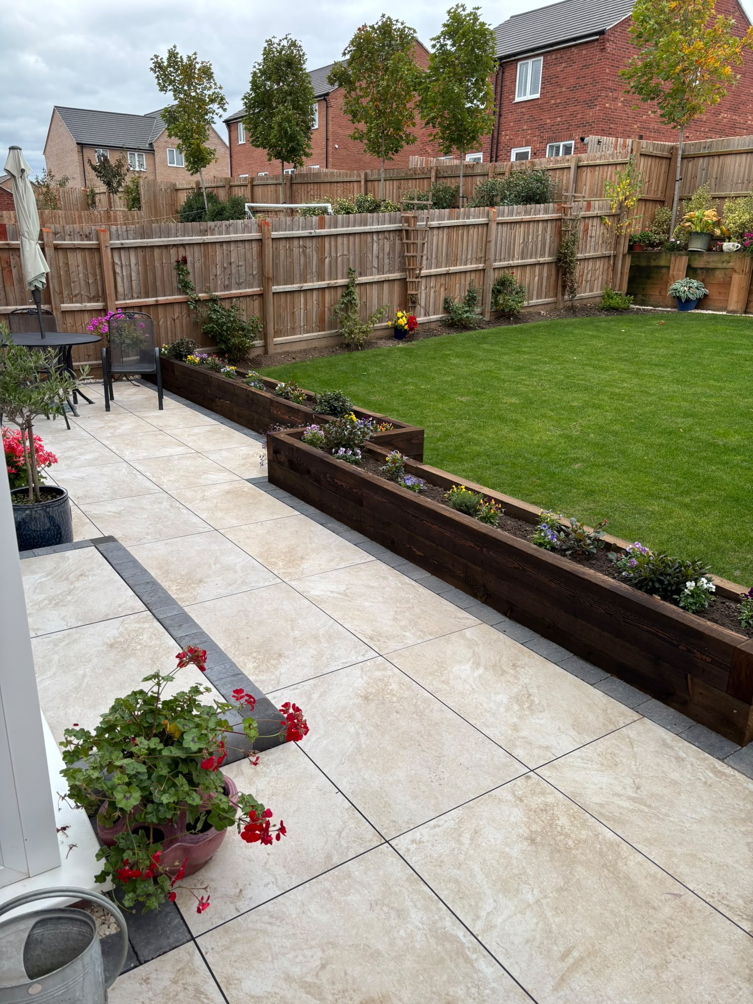 Newly installed patio paving in a landscaped back garden