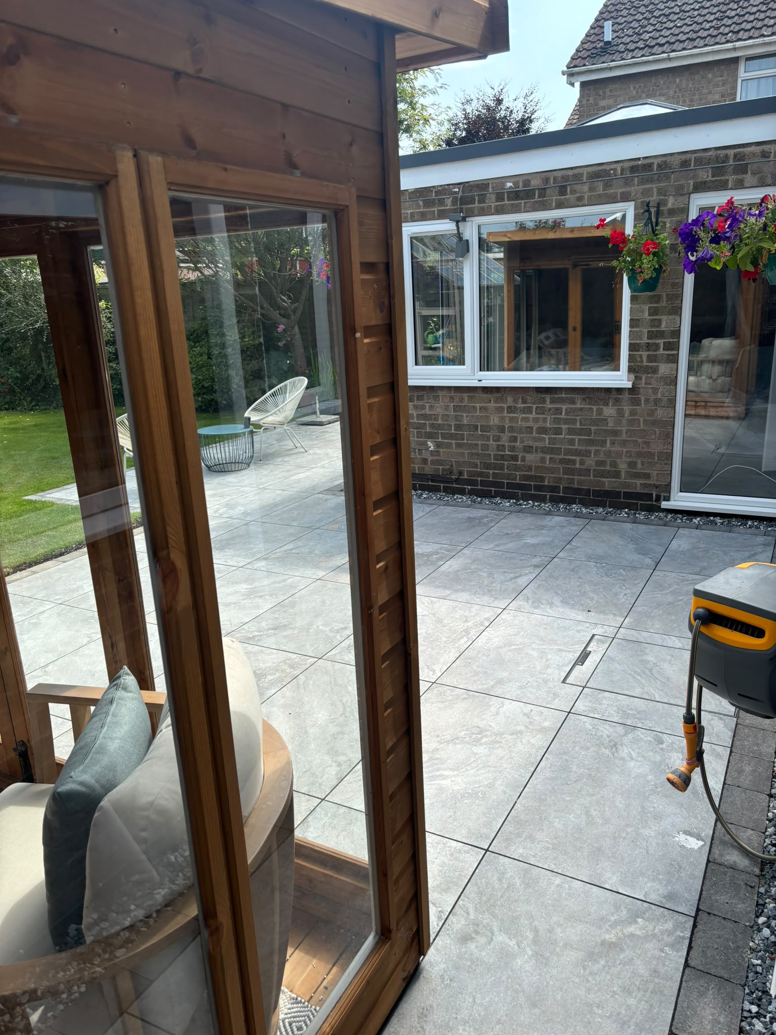 Newly installed patio paving in a landscaped back garden