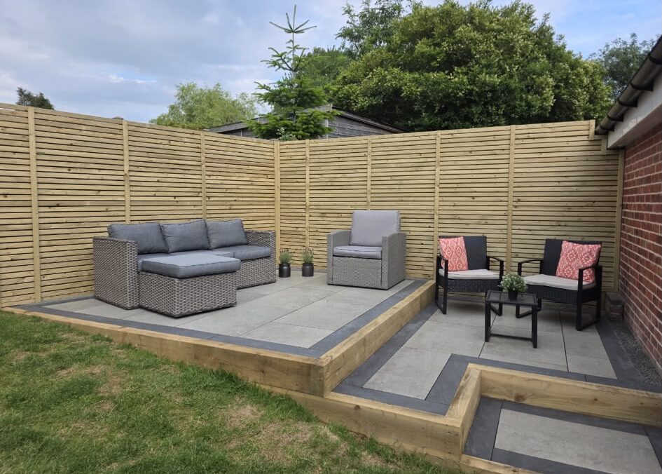 Paved seating area in a professionally landscaped back garden