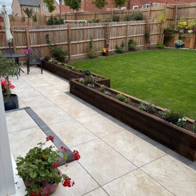 Newly installed patio paving in a landscaped back garden