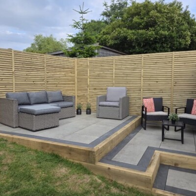 Paved seating area in a professionally landscaped back garden